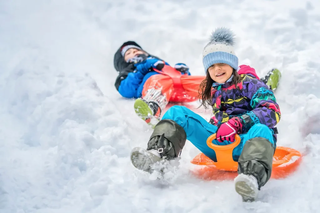 Kids Sledding On Snow